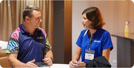 Two DakTech staff talking at a conference table