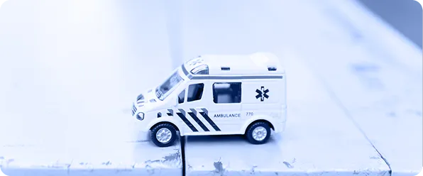 A toy ambulance on a desk