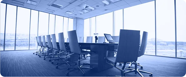 An empty boardroom with a long table