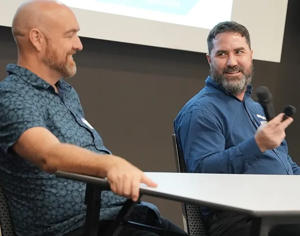 Daniel Kendall speaking on a panel beside a colleague